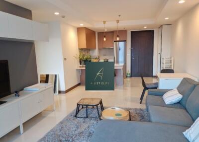 Modern living area with kitchen in the background