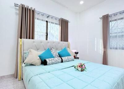 Bright bedroom with a large bed and decorative pillows