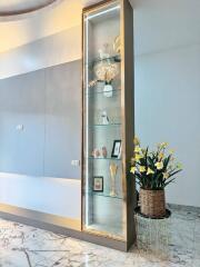 Modern living room with glass display cabinet and potted flowers