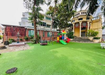 Spacious garden with playground equipment