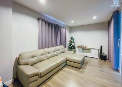 Cozy living room with sectional sofa and a Christmas tree