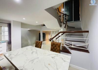 Modern kitchen and dining area with staircase