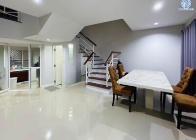 Modern living area with dining table and staircase