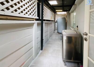 Clean and well-lit laundry area with washing machine