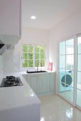 Modern kitchen with white cabinets and natural light