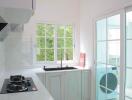 Modern kitchen with white cabinets and natural light