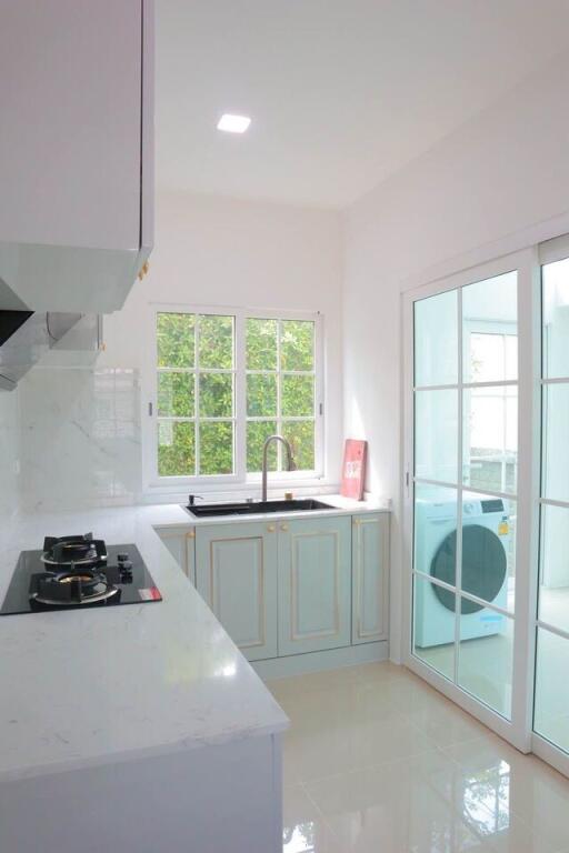 Modern kitchen with white cabinets and natural light