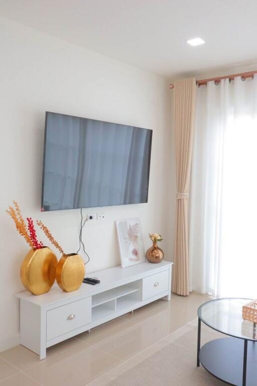 Modern living room with mounted TV and decorative vases