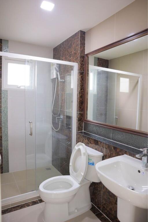 Modern bathroom with shower, toilet, and sink