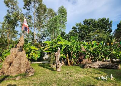 Outdoor garden area with trees and flag