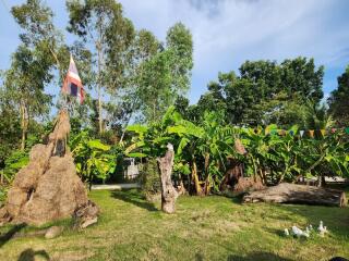 Outdoor garden area with trees and flag