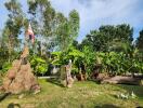 Outdoor garden area with trees and flag