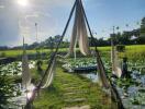 Peaceful outdoor area with walkway over water surrounded by greenery