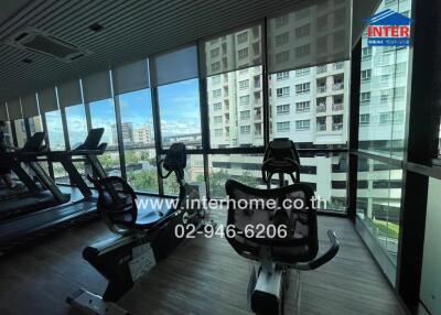 Fitness center with exercise equipment and large windows