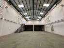 Spacious warehouse interior with high ceilings and mezzanine level