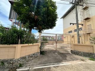 Front view of a residential building with gated entrance