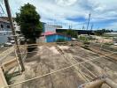 Spacious outdoor area with paved ground and laundry lines