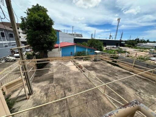 Spacious outdoor area with paved ground and laundry lines