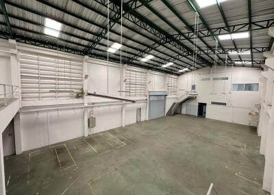 Spacious industrial warehouse with high ceilings and loading dock