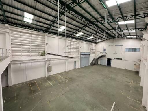 Spacious industrial warehouse with high ceilings and loading dock