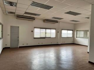 Spacious open area with wooden flooring and ceiling lights