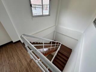 Staircase with wooden steps and metal railings