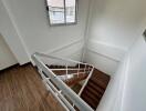 Staircase with wooden steps and metal railings