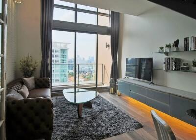 Modern living room with large windows and balcony view