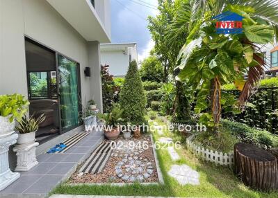 Beautifully landscaped garden with various plants and seating area