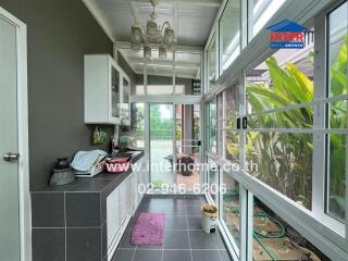 Bright kitchen with large windows and modern appliances