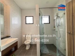 Modern bathroom with shower area and toilet