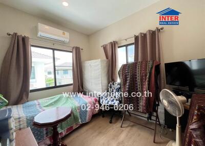 Bedroom with modern furnishings, air conditioner, and natural lighting