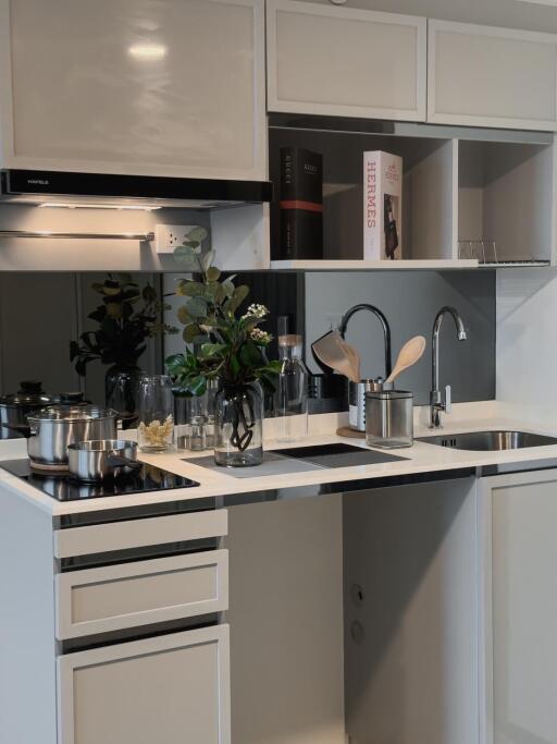 Modern kitchen with white cabinets and stainless steel appliances