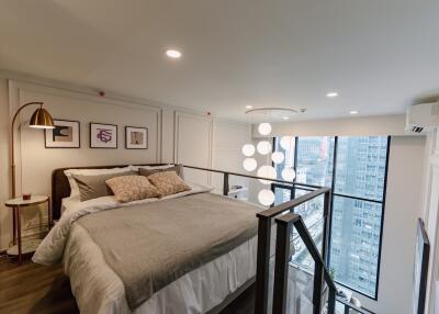 Modern bedroom with large windows and city view