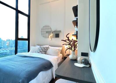 Modern bedroom with large window and stylish decor