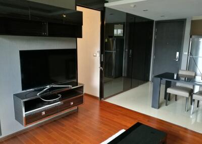 Modern living area with TV and dining space