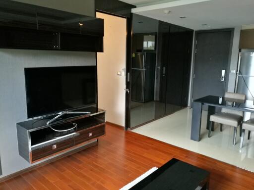 Modern living area with TV and dining space