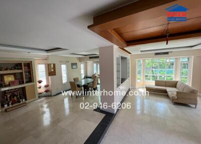 spacious living area with large windows and dining space