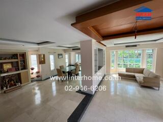 spacious living area with large windows and dining space