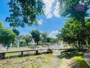 Scenic view of a landscaped garden with a small pond and a bridge