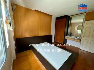 Bedroom with wooden floor and built-in wardrobe