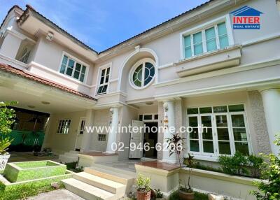 Front view of a two-story house with landscaped garden