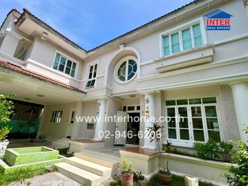 Front view of a two-story house with landscaped garden