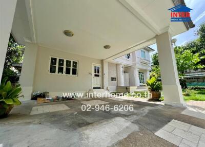 Covered garage area with a partial view of the house