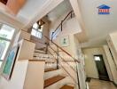 Bright staircase area with wooden steps and handrails