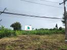 Open land with trees and a signboard