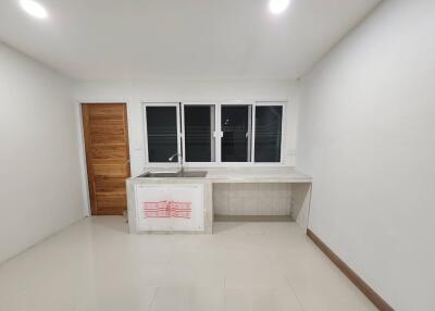 Minimalist kitchen with wooden door and large windows