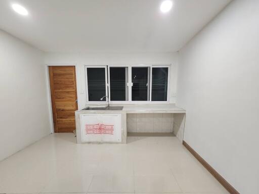 Minimalist kitchen with wooden door and large windows