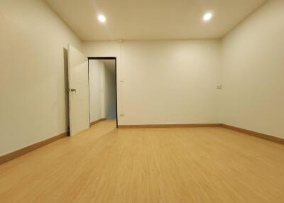 Empty room with wooden flooring and open door