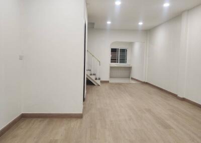 spacious living room with wooden flooring and staircase